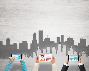 Top view of businesspeople sitting at table and using gadgets