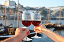 Wine Glasses In The Hands Against Douro River In Porto, Portugal