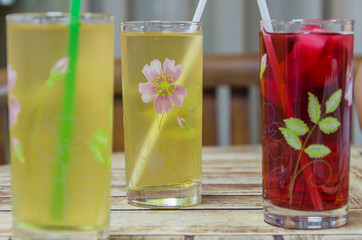 Wall Mural - Glasses with fresh orange juice and fruit on table