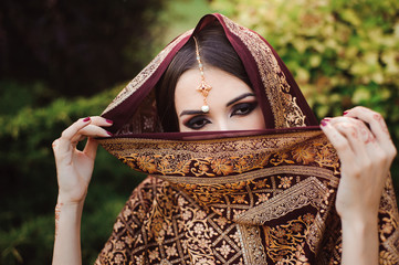 Wall Mural - Portrait of beautiful indian girl . Young hindu woman model with tatoo mehndi and kundan jewelry.