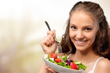 Wall Mural - Young woman with bowl of salad