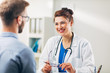 © Suteren Studio - Woman Doctor talking to Patient at her Medical Office