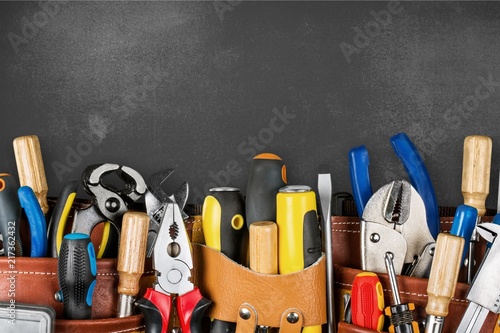 Cuadros en Lienzo Tool belt with tools on wooden background