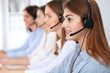 © rogerphoto - Call center. Beautiful cheerful smiling operator consulting clients with headset. Business concept of customer service