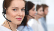 © rogerphoto - Call center. Beautiful cheerful smiling operator consulting clients with headset. Business concept of customer service