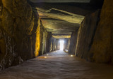 Fototapeta Desenie - Sun rays entering at Dolmen de Soto chamber. Sun-aligned megalithic monument, Trigueros,Spain