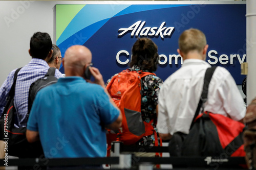 Air Alaska Passengers Wait At The Customer Service Desk Following