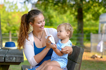 young mother cleaning her young son after eating