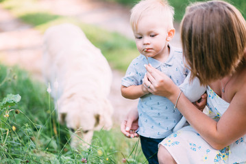 Cute cheerful child with mother play outdoors in park