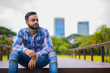 © Ranta Images - Young Handsome Indian Man In Park Thinking