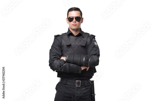 Photographie Seriuse cop in sunglasses, uniform with body armor