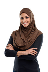 Poster - half-length portrait of smiling muslim girl standing with crossed arms. simple and modest outfit inc