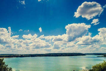 Wall Mural - Aerial view of the countryside and the river. Blue sky with beautiful clouds