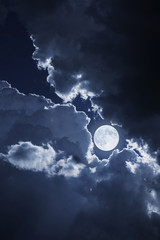 Wall Mural - dramatic nighttime clouds and sky with beautiful full blue moon