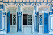 Colorful ancient antique blue wooden window Colonial style architecture building on white cement wall