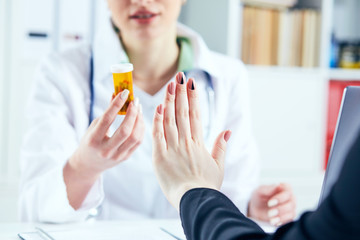 Female patient at the doctor appointment refuses to take prescribed medications, believes that they are useless and these biological drugs will only cause harm to his body.