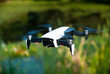 © JanMelichar - White drone flying near small lake