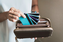 Young Woman Putting Credit Cards In Her Wallet