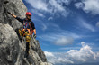 © lightpoet - Young man climbing on a rock in Swiss Alps - via ferrata/klettersteig
