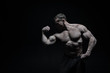 © be free - Perfect body. Man bodybuilder posing with tense muscles on black background. Bodybuilder achieved best shape for muscles. Ready for championship. Bodybuilder perfect muscular body, copy space