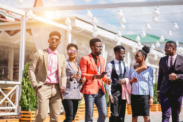 african young people have individual stylish outfit are standing outdoors