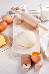 Wall Mural - Dough preparation recipe for bread, pizza, pasta, cookies or pie ingridients, food flat lay on kitchen table background. Working with butter, milk, yeast, flour, eggs, sugar pastry or bakery cooking.