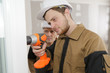 © auremar - apprentice construction worker drilling a wall