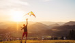 © Soloviova Liudmyla - Father and son start to fly a kite together