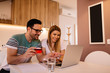 © Nebojsa - Portrait of young couple who is shopping online using credit card from their home