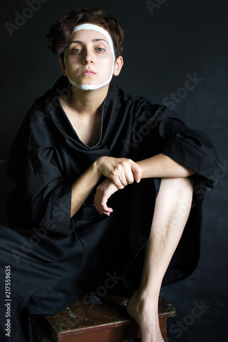 Photo Girl With Curly Short Hair In Voluminous Black Clothes With