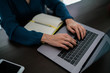 © eskstock - Cropped image of woman internet user keyboarding text of email letter while sitting at table with computer. Young female person browsing internet while using wireless connection on laptop.