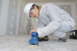 © auremar - female builder sanding floor