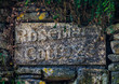 Rosemary Cottage stone sign in a stone wall, Cotswolds, England
