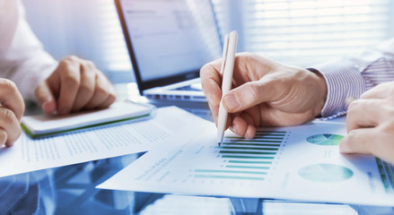 business analytics, team of people working on financial report in the office, teamwork, closeup of hands