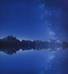 Wall Mural - beautiful inspirational landscape, night stars and milky way over Alps mountains outdoor with reflection and copyspace, nature background