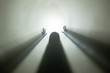 Licht am Ende des Tunnels - Silhoutte einer weiblichen Person im Gegellicht mit Nebel, die die Hände hebt