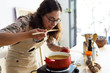 © nenetus - Beautiful woman tasting the food while cooking in an organic store.