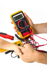 Digital multimeter on hand on white background