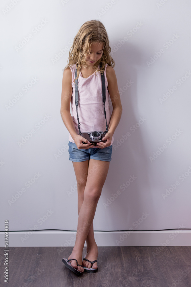 pim pandhost images share portrait of a young beautiful kid holding a vintage camera and smiling.  white background. Kids indoors. Photography concept Stock Photo | Adobe  Stock
