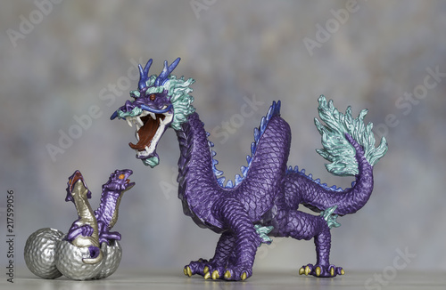 Fotografie, Obraz Purple Dragon Figurine Protecting Its Hatching Chicks