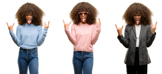 Poster - African american young woman wearing different outfits shouting with crazy expression doing rock symbol with hands up. Music star. Heavy concept.