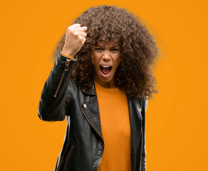 Canvas Print - African american woman wearing a leather jacket annoyed and frustrated shouting with anger, crazy and yelling with raised hand, anger concept