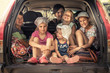© splendens - Group of children in family car trunk luggage going to road trip in family car symbolizing kids togetherness friendship and happy carefree childhood