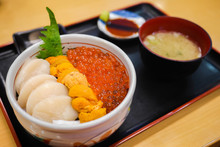 Tasty And Delicious Sushi Donburi Or Japanese Rice Bowl Topped With Fresh Sashimi Hotate(scallop),Ikura(salmon Roe) And Uni(Sea Urchin) With Wasabi At A Restaurant. Healthy Eating And Eat Well Concept