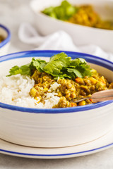 Wall Mural - Lentil curry with rice, Indian cuisine, tarka dal, white background. Vegan food.