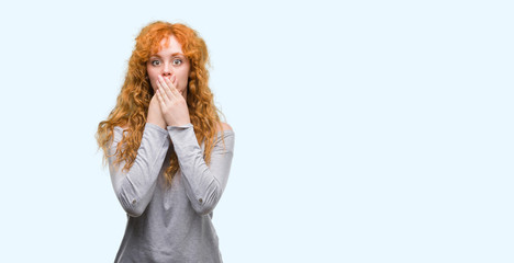 Canvas Print - Young redhead woman shocked covering mouth with hands for mistake. Secret concept.