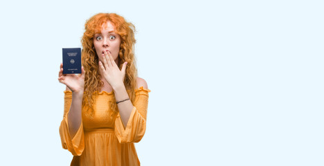 Wall Mural - Young redhead woman holding passport of Germany cover mouth with hand shocked with shame for mistake, expression of fear, scared in silence, secret concept