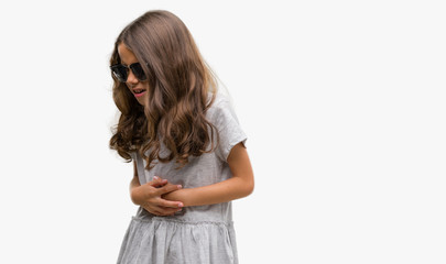 Sticker - Brunette hispanic girl wearing sunglasses with hand on stomach because nausea, painful disease feeling unwell. Ache concept.