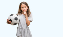 Brunette Hispanic Girl Holding Soccer Football Ball Serious Face Thinking About Question, Very Confused Idea