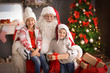 © New Africa - Little children and authentic Santa Claus indoors